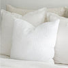 White waffle euro pillow styled with linen and boucle pillows in shades of white and cream. All sold separately. White waffle pillow is made of 100% cotton with a luxe down insert. Measures 26" x 26".