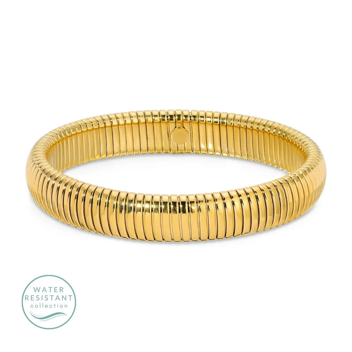Gold coil bangle. Waterproof. 18K gold PVD plating over premium stainless steel. .46 inch width. 7.5 inch circumference.
