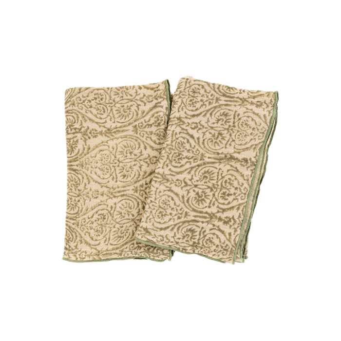 Two gauze hand towels block printed in a green winter vine pattern on a neutral ground. Edges finished in a green satin stitch. Sold individually. Measures 20 x 26 inches.