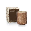 Woodfire Candle by Illume packaged in decorative box perfect for gift giving. Brown crackled glass container holds 8.3oz. plant based wax candle. Fragrance is grounded in smoky Cedar with a heart of suede kissed with earthy amber. 3.375" x 3.375" x 4.25". 