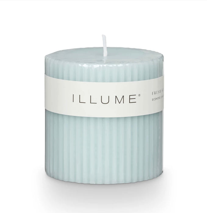 Fresh Sea Salt scented pillar candle. Soft aqua candle with a fluted profile. Fragrance notes grounded in fresh sea salt and jasmine. Comes with clear plastic wrapper. Measures 3" x 3". 