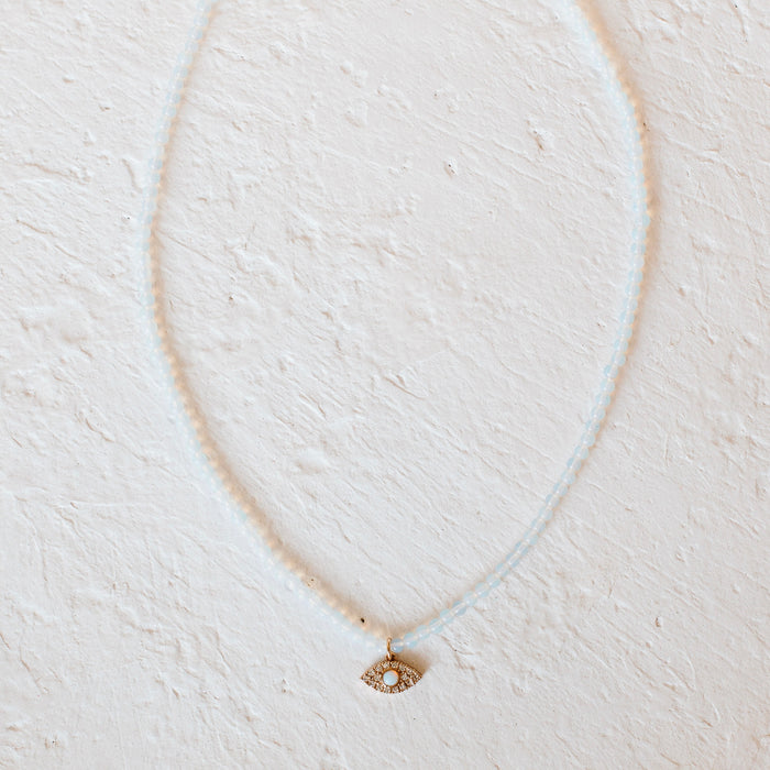 Moonstone Evil Eye Necklace. Small milky white moonstone beads with an opal and CZ encrusted evil eye pendant. Necklace measures 15" length with a 3 " extender.