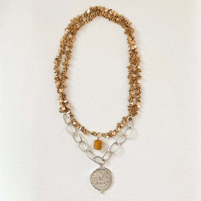 Bougie Boho Coin necklace hand crafted by Bittersweet Designs in New Mexico. 42" length shown double wrapped.  Made of gold plated pailettes with a large matte sterling silver chain and a vintage coin pendant cast in sterling silver with 3 diamond chips. Back clasp of necklace has a large amber charm. 