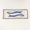 Pisces Stoneware Tray. Rectangular tray in a creamy white speckled stoneware with a hand painted cobalt blue border and fish design. Measures 12" length x 4.5". Perfect for serving small sides or tapas.