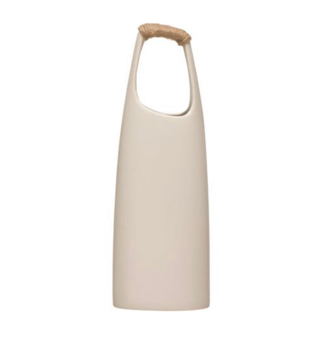 The Laguna Stoneware Vessel has a long, lean modern silhouette perfect for holding dried grasses or cut branches. Crafted from stoneware with a smooth white glaze. The  handle is hand wrapped in jute twine for a rustic finish. Measures 15.25" height, 13.5" circumference.