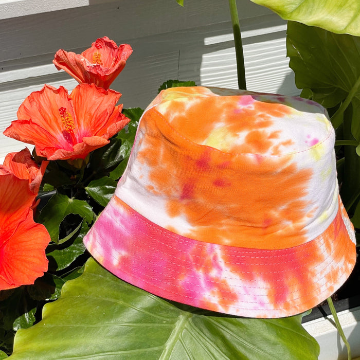 The Aiden bucket hat in hot pink + orange tie dye gives off all the tropical vibes you need to get your summer started.