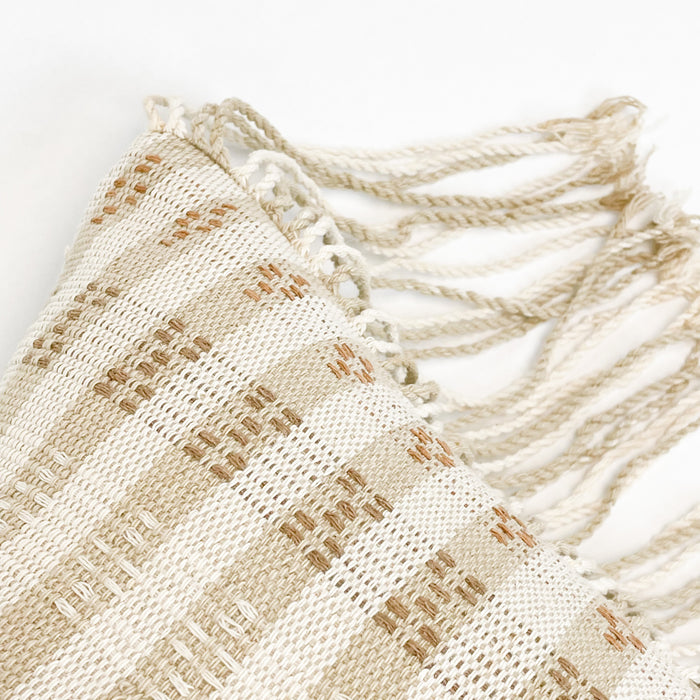 Close up of the Anya Pillow Cover showcasing the skilled weaving techniques of tribal weavers in Thailand. Hand twisted fringe edge adds beautiful texture.
