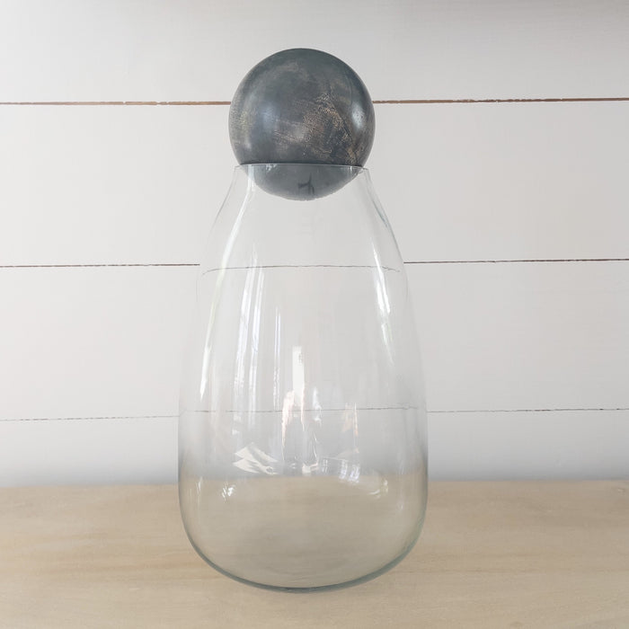 Clear glass decanter/canister with round wood ball stopper. Holds oz.