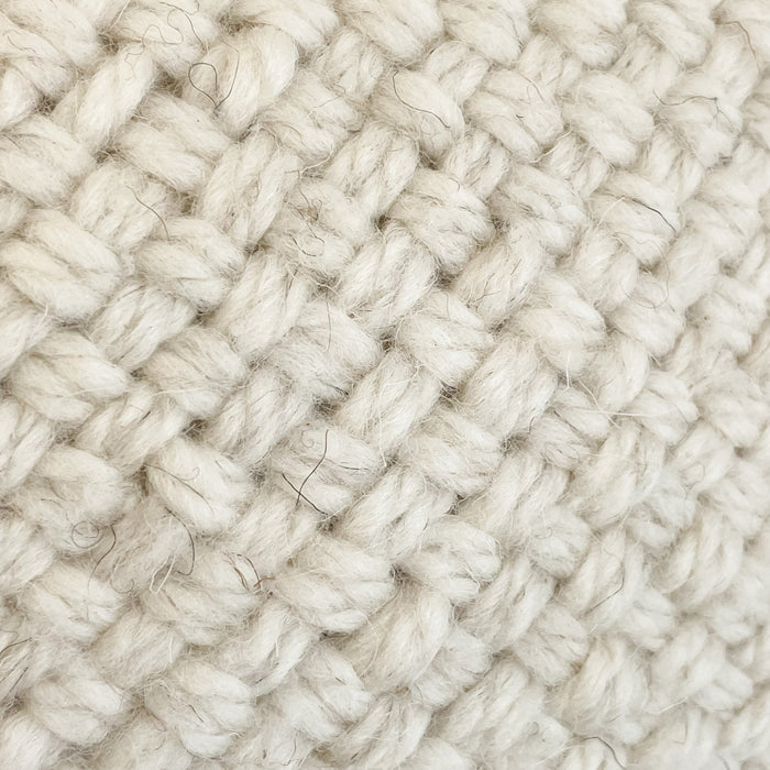 Layla Pillow Cover. Close up view of the woven texture.  Hand made from natural cream wool yarns. Measures 20” x 20”.