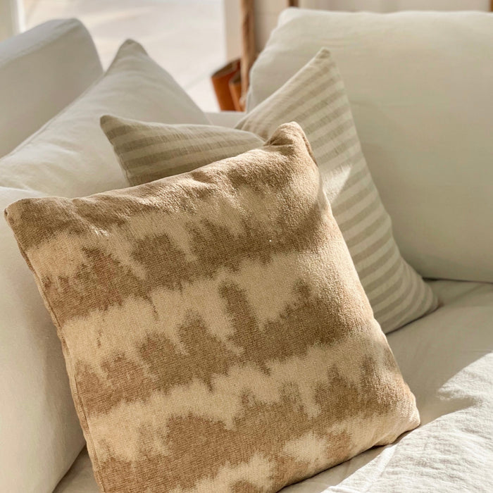 Neutral tie dye pillow shown with the White Sands stripe pillow. Each sold separately.
