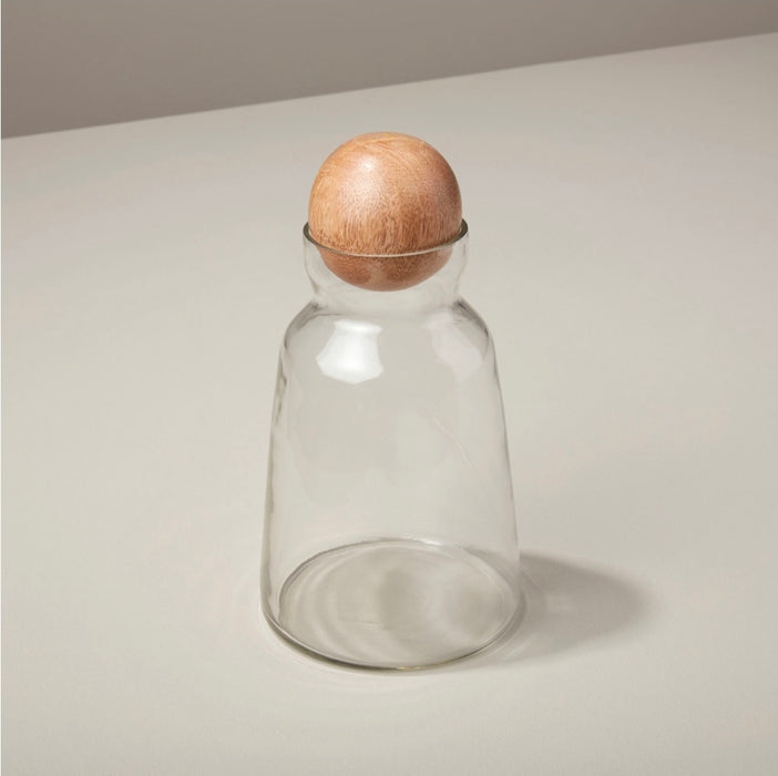 Short glass decanter with natural wood stopper. Holds 32 oz. Stylish dry goods storage for the modern kitchen.
