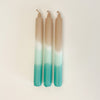 Set of 3 Dip Dye Candles inspired by the shoreline in shades of sand, seafoam green and turquoise add coastal color to your table setting. Hand dipped paraffin candles measure 8" length, 3/4" diameter. Set of 3 come packaged in a box, perfect for hostess gifts. 