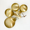 Set of 4 Brass Scoops. Perfect for use in the kitchen. Set of 4 comes on a suede string. 5.25"L. Hand wash only.