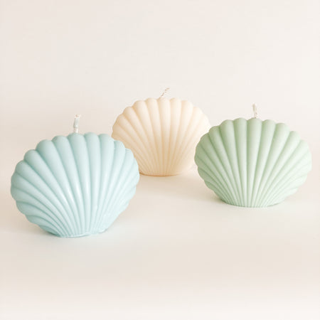 Collection of Seaside Shell candles available in 3 colors, blue, ivory and green. Hand poured by a female maker in California. Made from 100% unscented soy wax. Each sold separately.