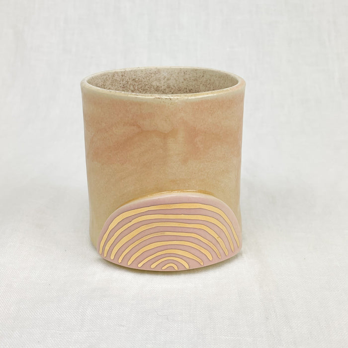 Golden Rainbow Ceramic Tumbler. Small cup with blush pink glaze and hand painted gold rainbow. Handmade by Curious Clay.