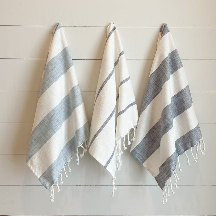 Blue & White Stripe Tea Towels are perfect for the coastal kitchen or bathroom. Set of 3 includes one light blue/white bold stripe, one dark blue/white fine stripe and one dark blue/white bold stripe. Made of 100% slub cotton with twisted tassel edge on one side.