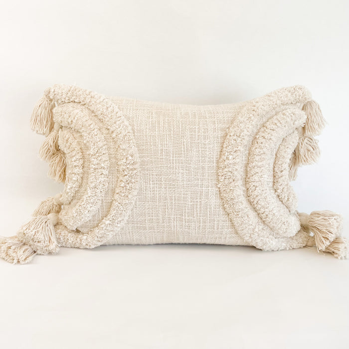 The Lulu pillow cover features tufted cream arches with hand knotted tassels on each end. The perfect accent for the modern boho home. Pillow base is a soft stubby cotton plain weave. Measures 14" x 20"
