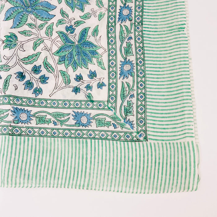 Gulf Blue Floral block print sarong from By the Sea Organics. Bordererd in a white and sea green stripe. Measures 46" x 72". 