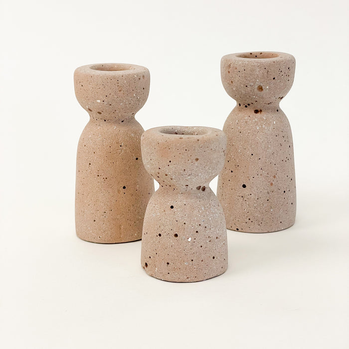 Grouping of terra cotta Minimalist Candle Holders. Sleek and sculptural made from hand cast concrete. Each sold separately.