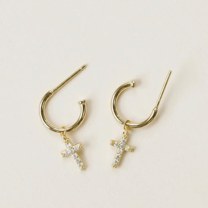 Delicate gold hoops feature a pave' encrusted cross charm. Hand-crafted in 14 kt gold vermeil with a sterling silver base.