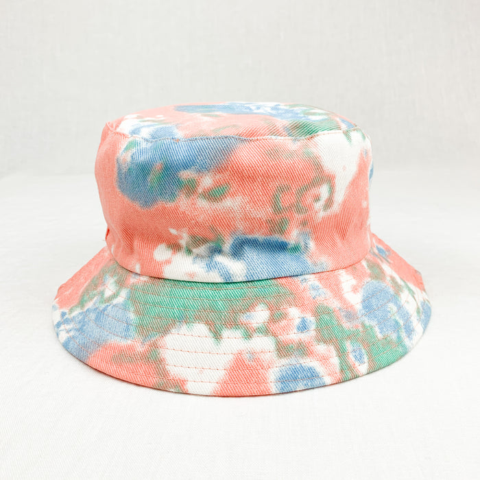 The Aiden Bucket Hat in swirls of coral and aqua tie dye is like wearing the good vibes while you protect yourself from the sun. 100% cotton twill in a traditional bucket shape. Measures approximately 24" around crown.