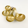 Set of 4 Brass Scoops in varied sizes. Perfect for use in the kitchen. Hand wash only. 5.25"L