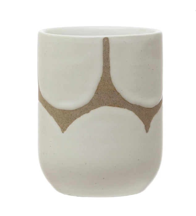 Small stoneware cup with a white scallop glazed pattern. Interior is coated with a milky white glaze. 4" high 3" diameter. Microwave and dishwasher safe.