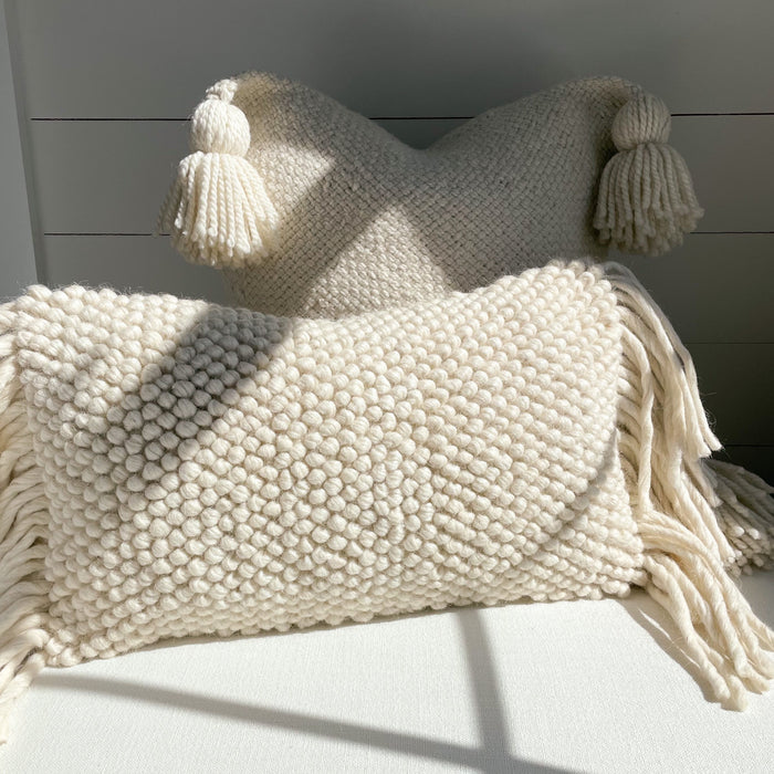 The Lola Pillow shown with our Layla Pillow. Both are hand made from thick natural cream wool. Each pillow cover is sold separately. Inserts not included.