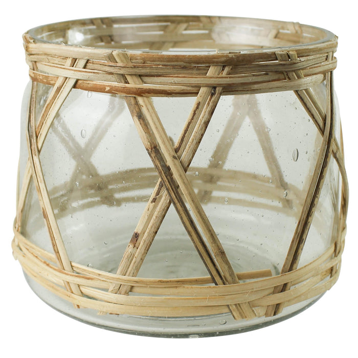 Rattan and Glass Hurricane adds a tropical spirit to any tabletop. Perfect for the modern boho home. Measures 6" diameter, 5.25" H