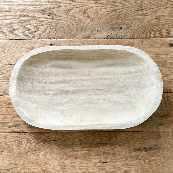 Our Whitewash Wood Platter is a beautiful addition to any table or counter. Hand carved in natural Paulownia wood and treated with a whitewash finish giving it an airy driftwood appearance. It's large size makes it a perfect  centerpiece on the kitchen island or table. Measures 23"L 13"W.