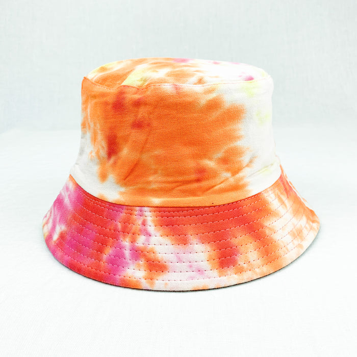 Aiden Bucket Hat in bright pink and orange tie dye. Wear good vibes while protecting yourself from the sun. 100% classic bucket hat lined in cotton. Measures approximately 24" around crown.