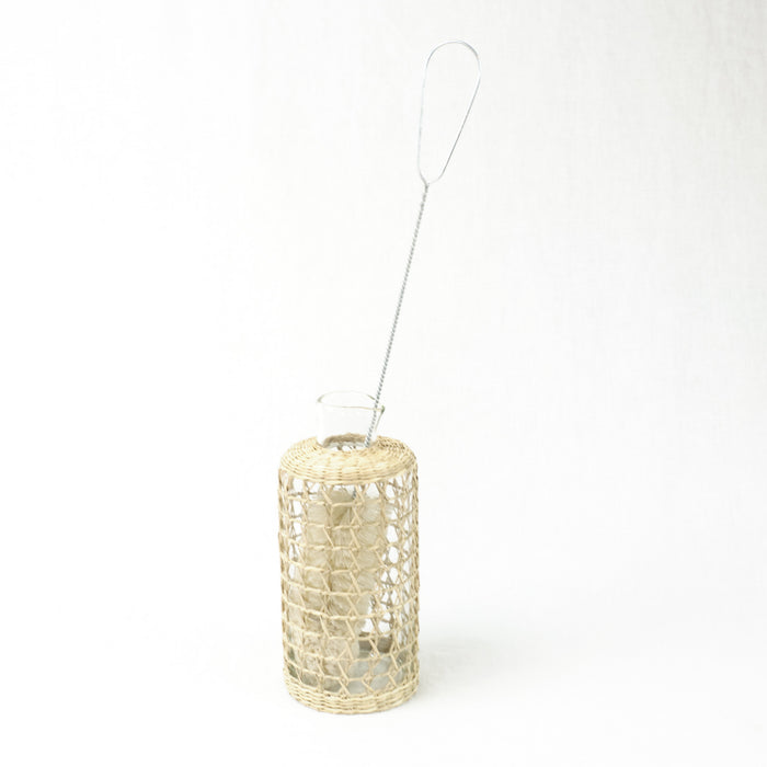 Bottle brush in a glass carafe with a seagrass cage. Each sold separately.