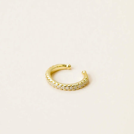 Pave' encrusted ear cuff adds a little edge to your earring stack. Hand-crafted in 14 kt gold vermeil with a sterling silver base and encrusted with small white cubic zirconia stones.