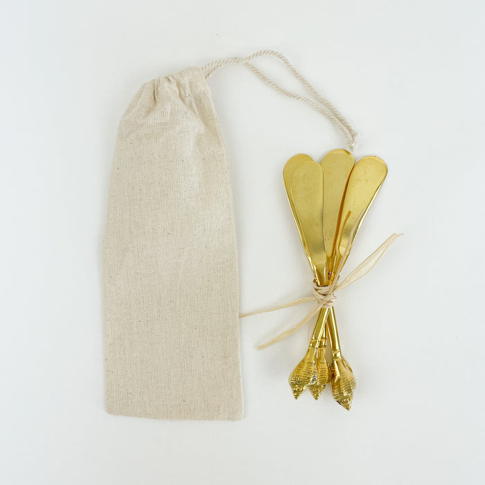 Set of 4 brass knives with brass seashell handle. Perfect for spreads and jams on your next charcuterie board. Comes in a cotton drawstring bag. Makes a perfect hostess gift. Measures 5.75" length. Hand wash only.
