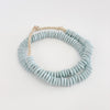 Pale Blue Ashanti beads make the perfect decorative accent in the modern coastal home. Hand made using traditional techniques in Ghana. Style them in a bowl or draped on the neck of a lamp. Approximately 26" length.