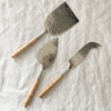 Set of 3 Rattan Wrapped Cheese Knives made of hammered stainless steel.