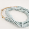 Pale Blue Ashanti beads make the perfect decorative accent in the modern coastal home. Hand made using traditional techniques in Ghana. Style them in a bowl or drape them on a lamp. Approximately 26" length.