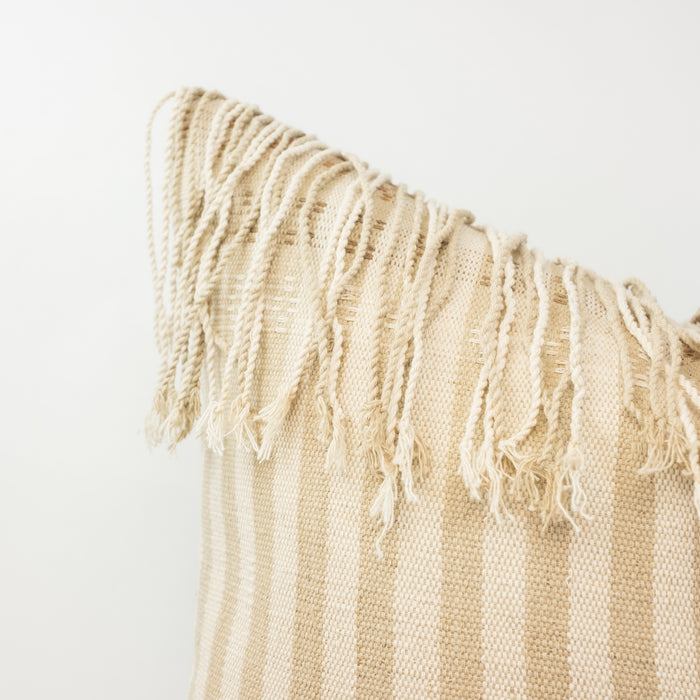 The Anya Pillow Cover has a hand twisted fringe edge, perfect for the modern bohemian home. One of a kind piece, handwoven by textile artisans in a palette of cream, sand and khaki stripes. Measures 20'x 20". Insert NOT included.