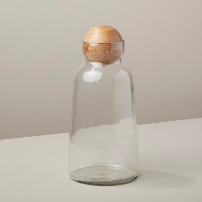 Medium glass decanter with natural wood stopper. Holds 42 oz. Stylish dry goods storage or a beautiful way to serve a cold beverage.