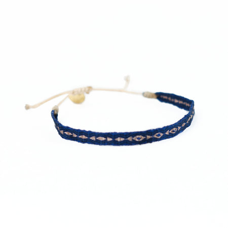 Deep Azure blue woven friendship bracelet with gold thread and azure glass beads. Adjustable cord to fit multiple wrist sizes.