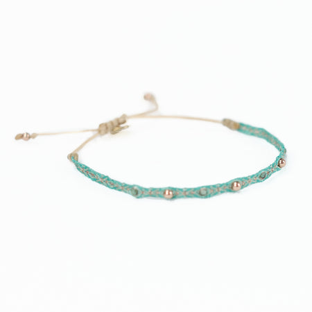 Aqua-Green woven friendship  bracelet embellished with gold thread, jade and brass plated beads. Adjustable waxed cord closure.