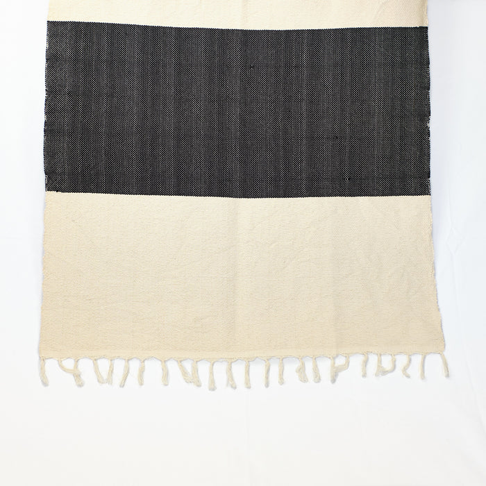 The Island throw, hand loomed in a traditional kilim weave in  cream with bold black stripe and fringe edge. Makes a perfect throw for the sofa, a beach blanket or rug. Hand made in Turkey.