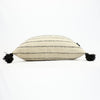 Natural wool pillow in cream with black stripes and black poms by Treko Wool.