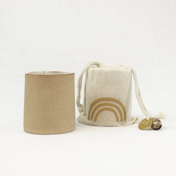 Earth scented soy candle in unglazed ceramic vessel. Comes in a muslin gift bag.