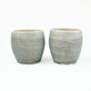 Two small blue-grey ceramic cups by Totem Home.