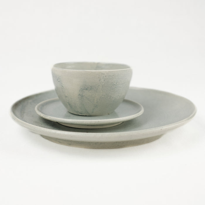 Table setting of Smoke ceramics by Totem Home. Includes dinner plate, side plate and bowl.