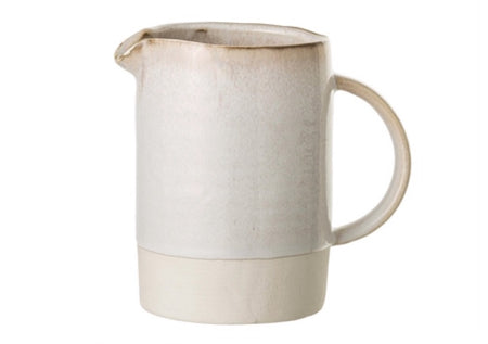 Milk + Cream Stoneware Pitcher looks like it’s name with a natural cream stoneware base and a glossy off white glaze with hints of a honey toned patina. Perfect accent for the modern farmhouse kitchen. Holds approximately 36 oz.  Measures 4" diameter and 6"H.
