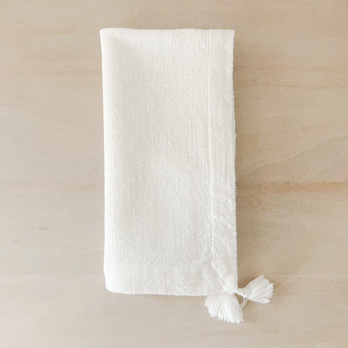 Ivory tassel napkin. 100% soft slub cotton with small hand knotted tassels on opposite corners. Adds effortless style to your table setting. 19" x 21". Each sold separately.