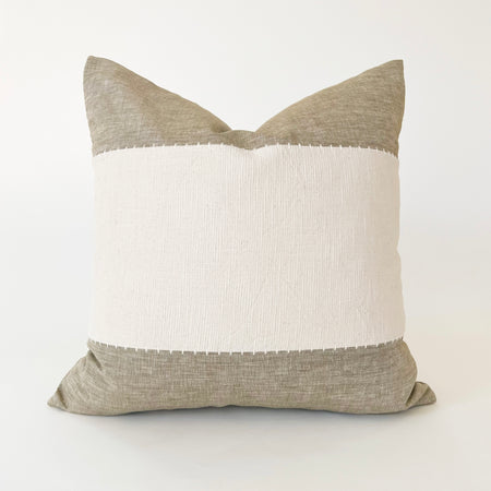 Square Hamptons pillow color blocked in tan and cream linen with hand whipstitching at the seams. 20 x 20 inch.