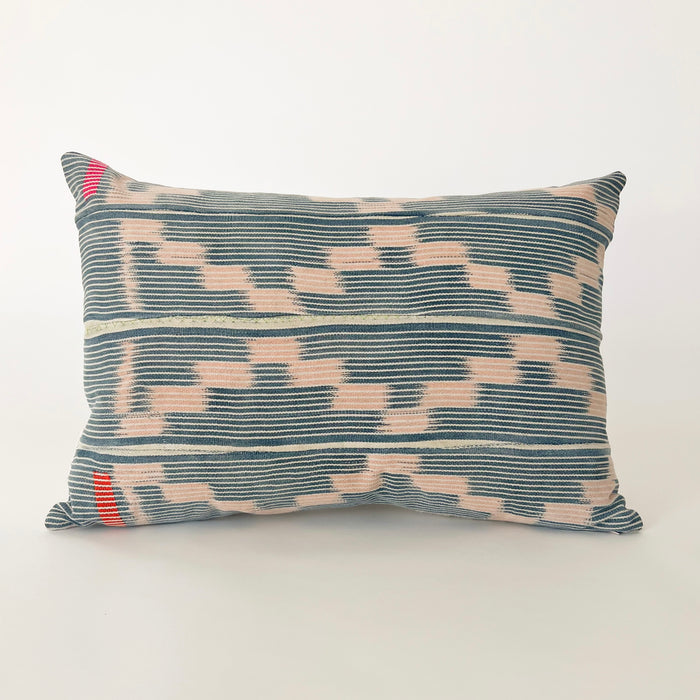 Small Amara pillow made from a blush & indigo Baule cloth. Indigo and natural stripes with a soft  pink zig zag pattern. Left side has a hand stitched blocks in fuchsia and orange. Back side is natural Belgian linen. Measures 19" x 13". Limited edition.
